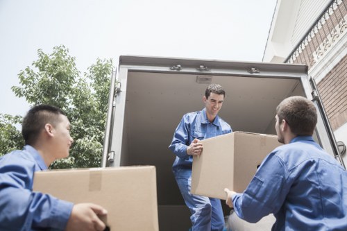 Movers carrying furniture during a house relocation