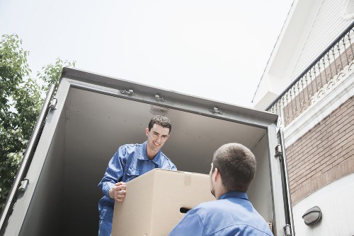 Removals team carrying boxes through a Southborough property